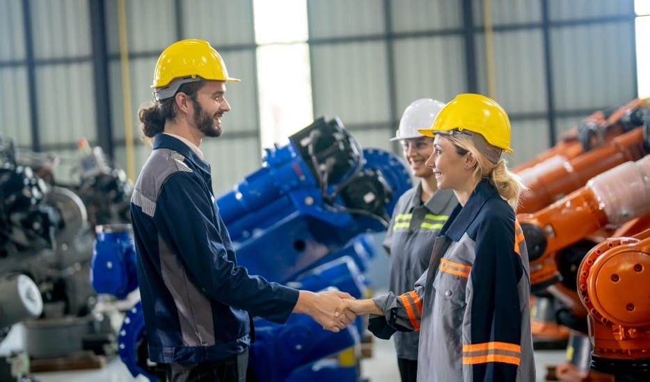 Engineers Shaking hands in a factory