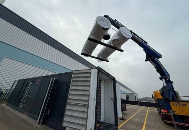 Crane lifting additional generator equipment